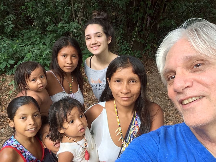 Professor Louis Forline poses with daughter and Amazonian community members in Brazil