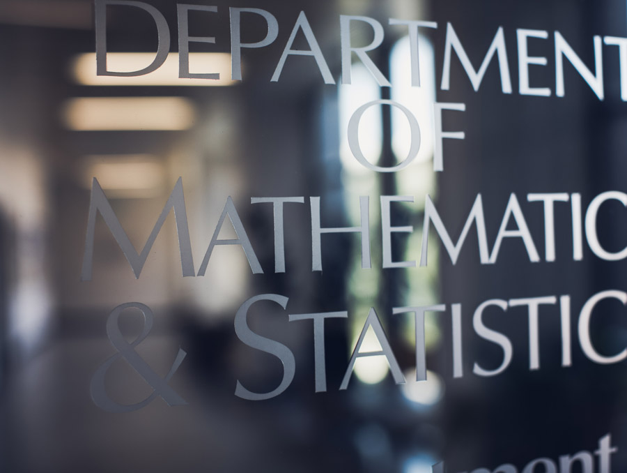 Image of a glass door with "Department of Mathematics and Statistics" etched on it.