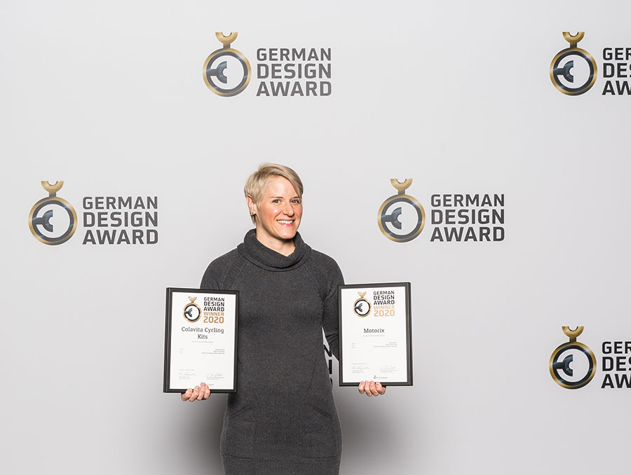 Monica Maccaux holding two design awards at the German Design Awards 2020 event