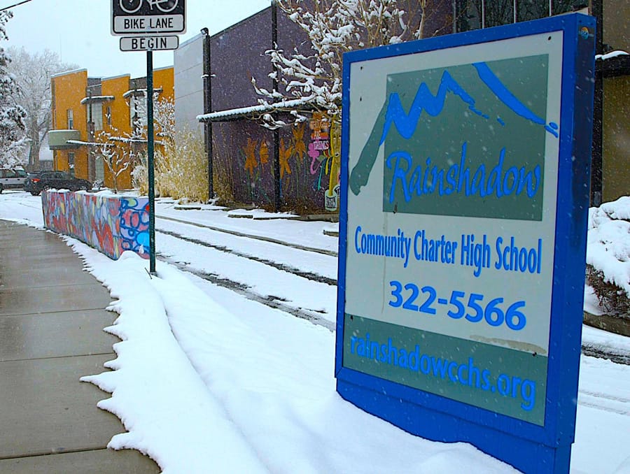 Rainshadow Community Charter High School school sign outdoors in winter.