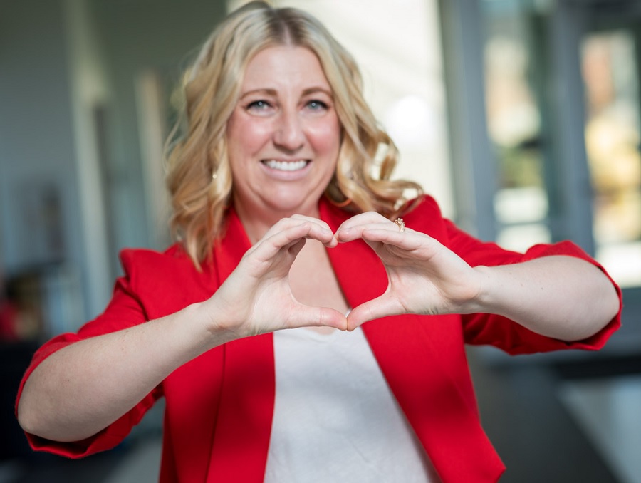 Dr. Lorrel Toft, associate professor and cardiologist, makes a heart with her hands