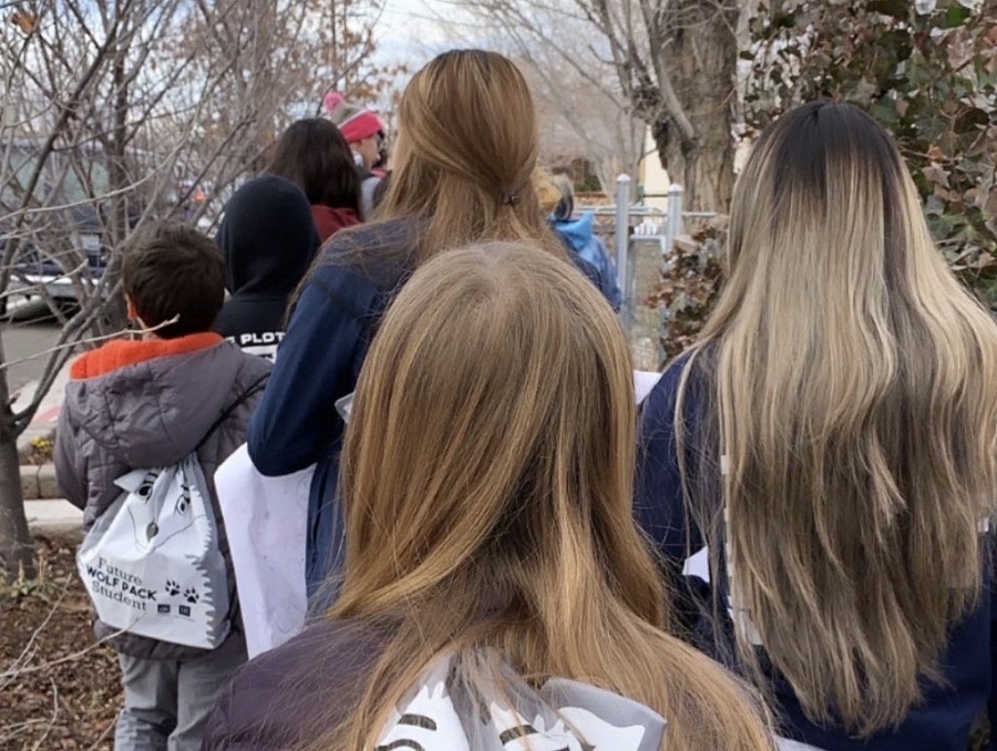 Children from the Boys and Girls Club walking down the street in a silent protest