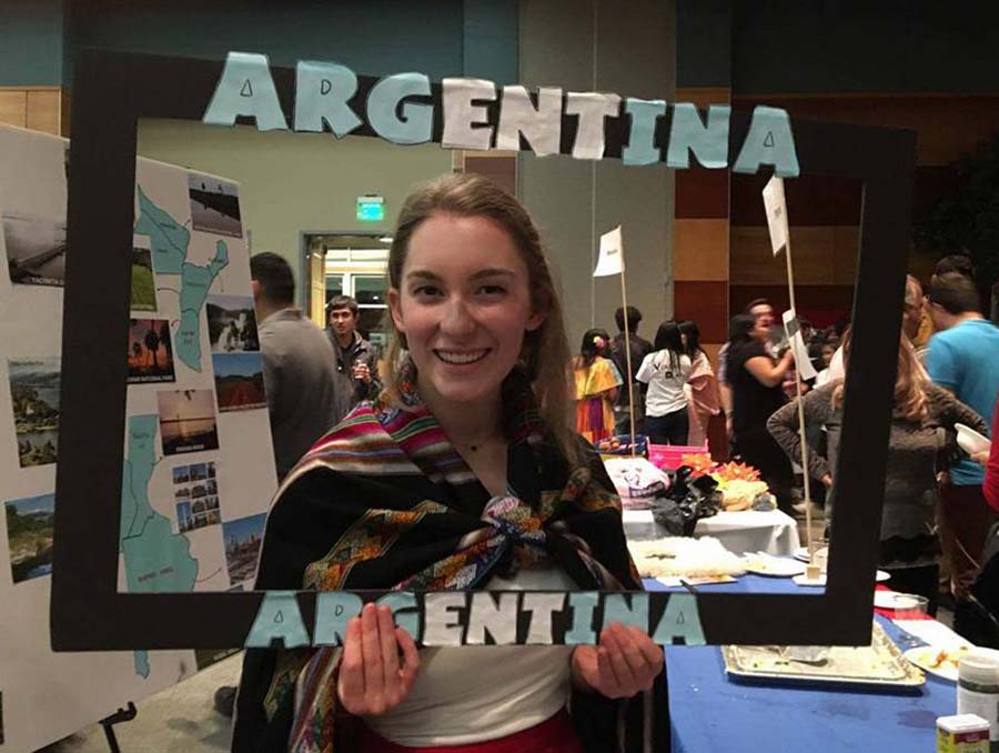 Student holding up Argentina cardboard frame