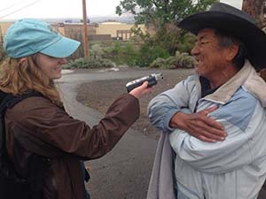 Student interviewing a day laborer while reporting for Noticiero Móvil. 