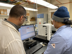 Yftah Tal-Gan and graduate assistant Anthony Harrington at a monitor running a laboratory test.