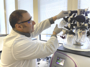 Researcher Yftah Tal-Gan operating the lab's peptide freeze-drying machine.