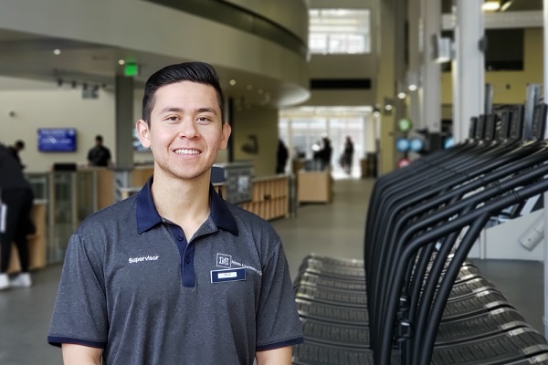 Kyle Harris standing in front of some treadmills in E.L. Wiegand Fitness Center