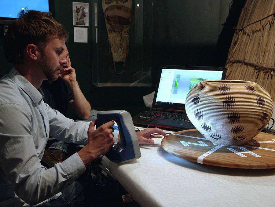 Luka Starmer uses a 3D scanner to capture the Dat So La Lee basket which can be viewed at the Nevada Historical Society