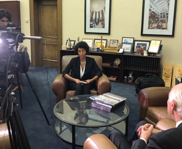 A student records another student and the president of the university during an interview.