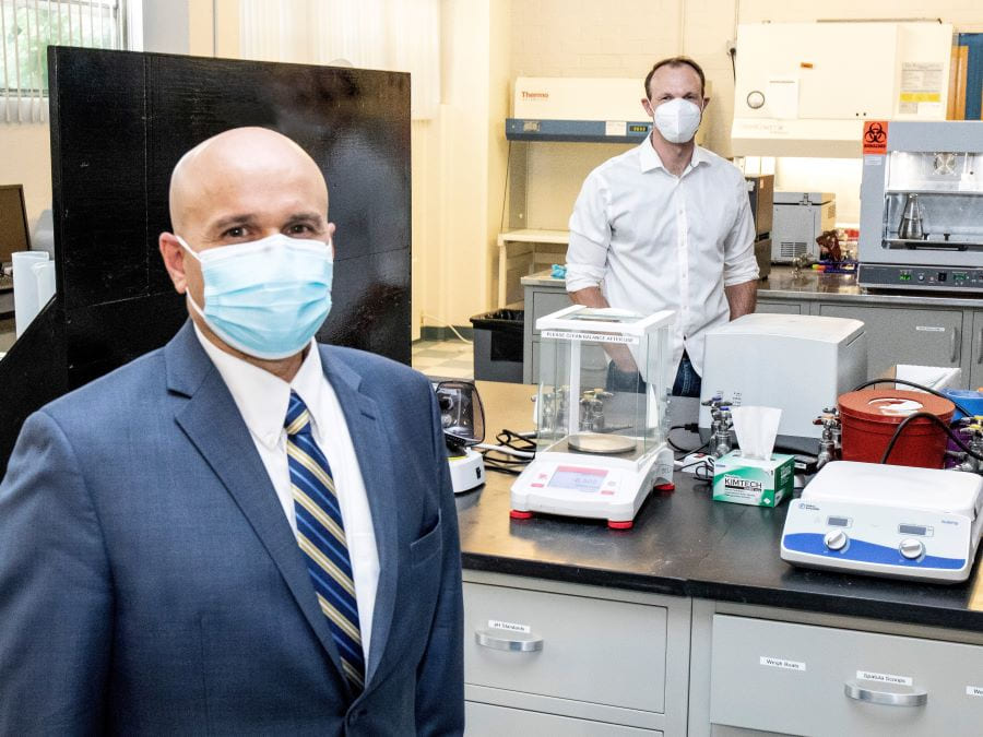 Carlos Cardillo of the Nevada Center for Applied Research and Jonathan Hull of Bioelectronica stand in the biosciences laboratory managed by NCAR.