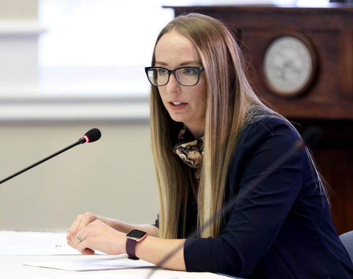 Kyra Morgan speaking at a press conference.