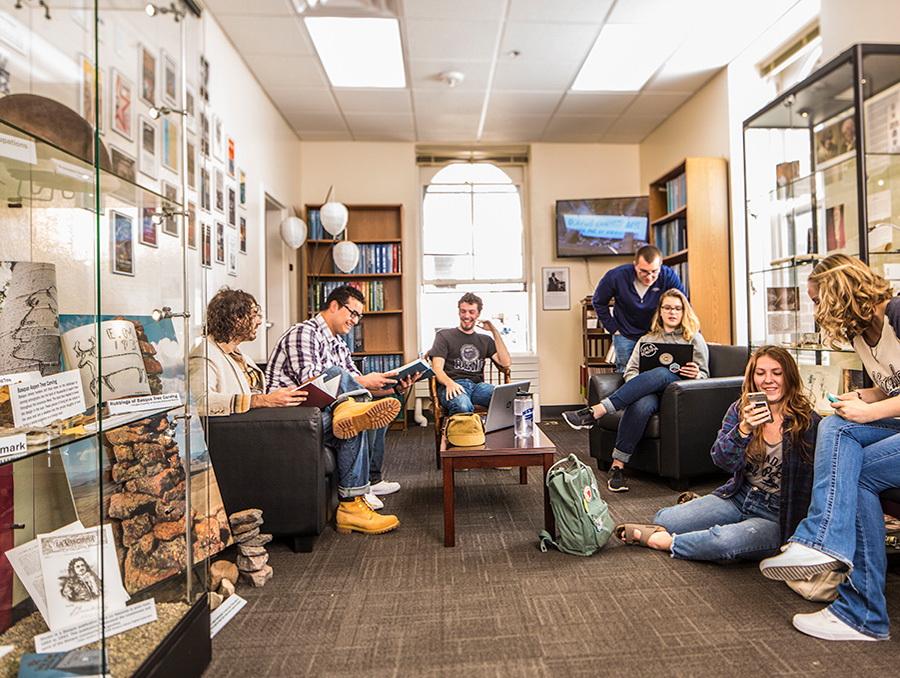 Students sitting in exhibition room talking