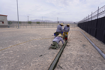 Workers installing track at correctional facility 