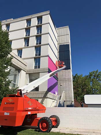 Mural artist Rafael Blanco begins work on a mural on the Sierra Hall building at the University of Nevada, Reno.