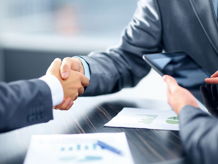 two people in business suits shaking hands