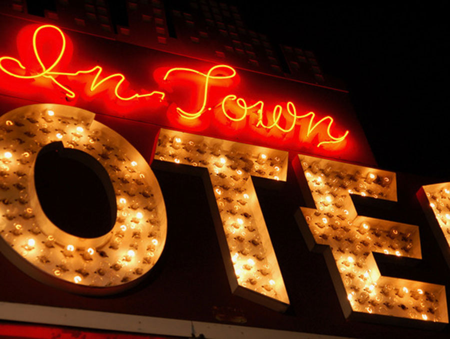 Neon sign that reads "In Town Motel"