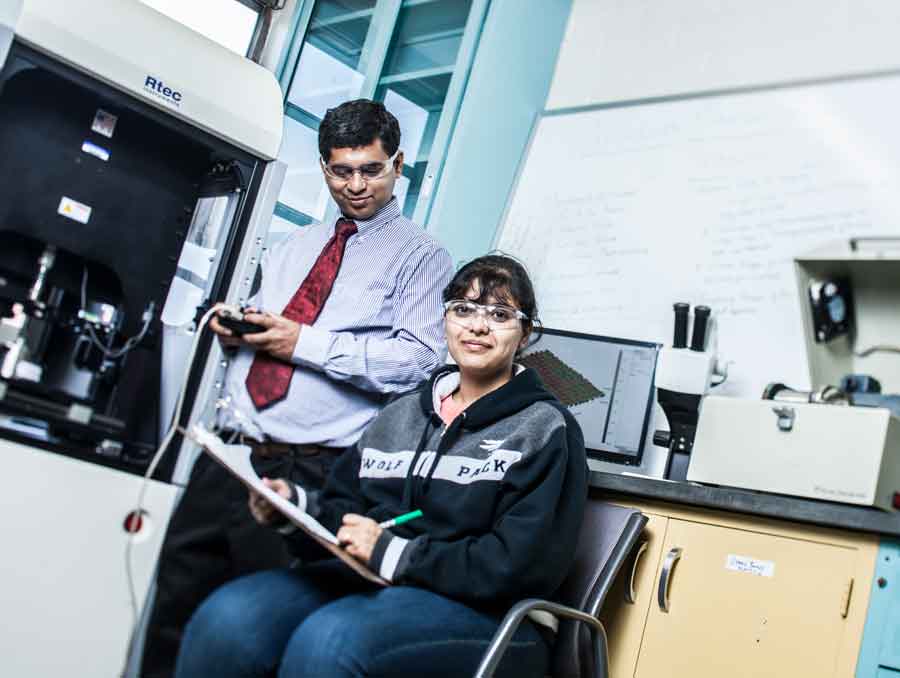 A photo of Pradeep Menezes in a lab with one of his students. 