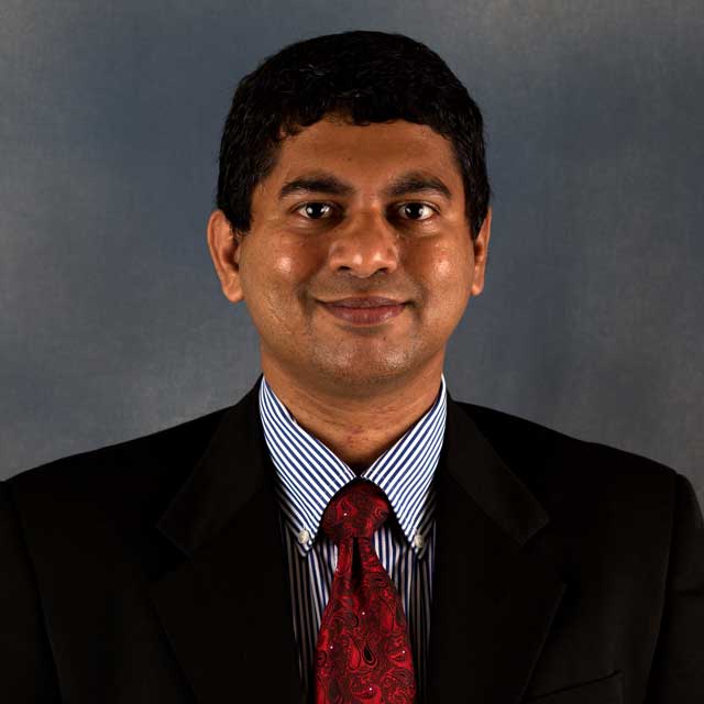 A headshot of Pradeep Menezes.