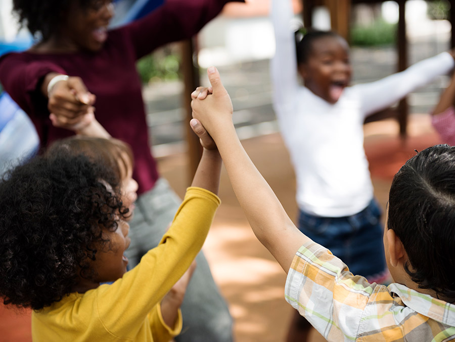 Group of diverse children holding hands