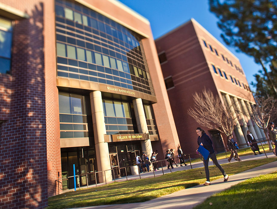 William Raggio building on campus with students out front in the summer