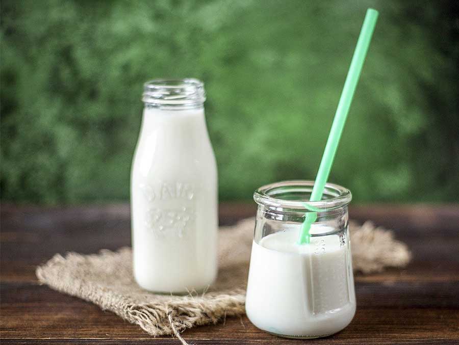 A jar and glass of milk on a table