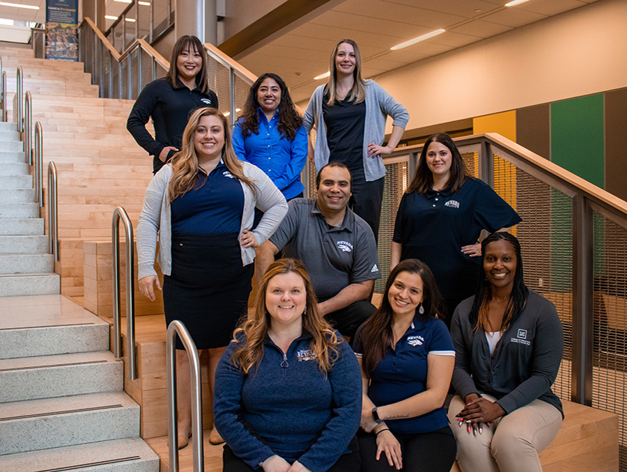 College of Liberal Arts advising team sits on stairs in Pennington Achievement Center