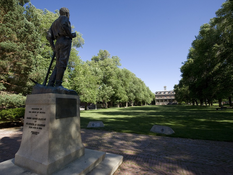 A photo of a statue of John Mackay and the Quad.