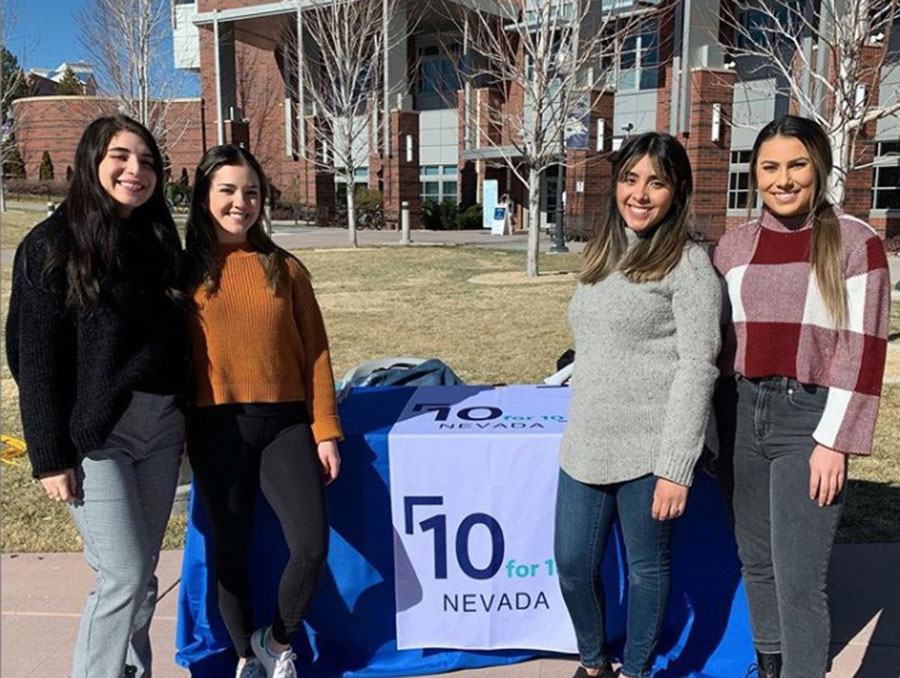 Four students pose outdoors.