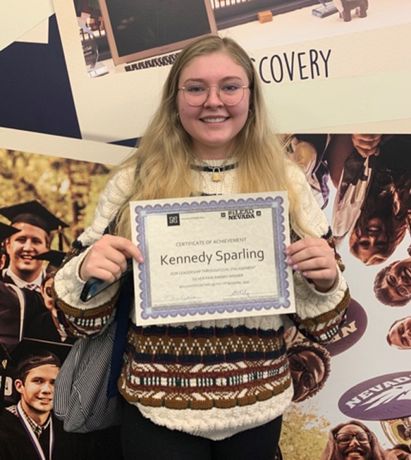 Kennedy Sparling holds Richard & Bonnie Bryan Family Public Service Award