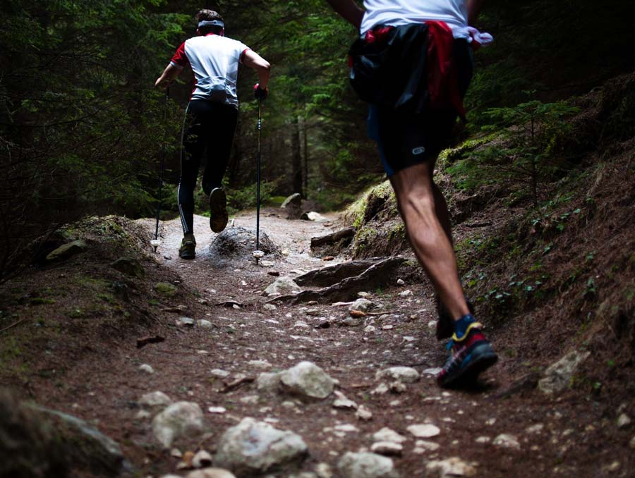 two men ascending a hiking trail while at least 6 feet apart