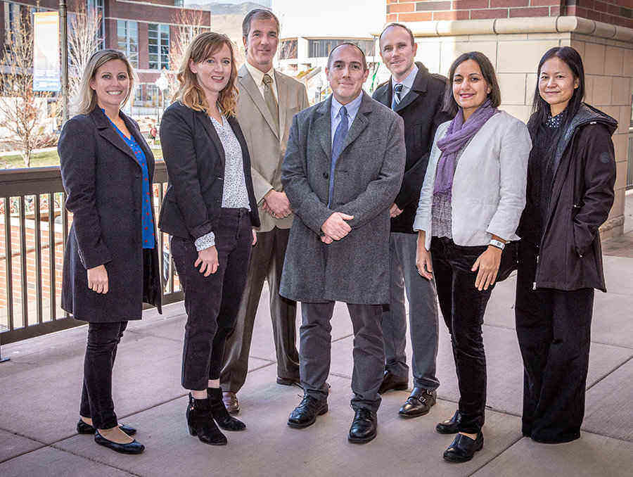 Teaching & Learning Technologies and the Instructional Design Team stand in a group on the landing out front of the main entrance of the Mathewson-IGT Knowledge Center.  From left to right: Kathy Hanselman, Kari Johnson, Don Massie, Ed Huffman, Bowen Drewes, Lia Schraeder and Wenzhen Li.