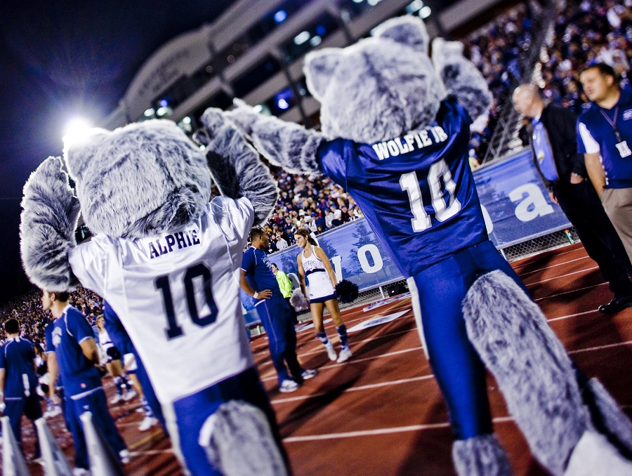 Wolfie, Jr. and Alphie cheering on the Pack at a football game