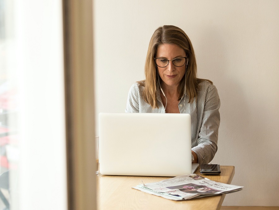 Woman using laptop while sitting