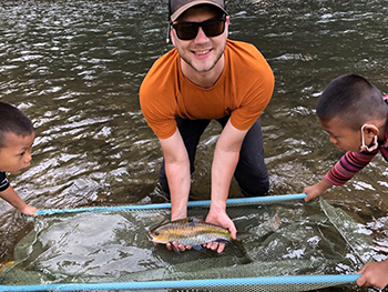 Aaron releasing fish after tagging