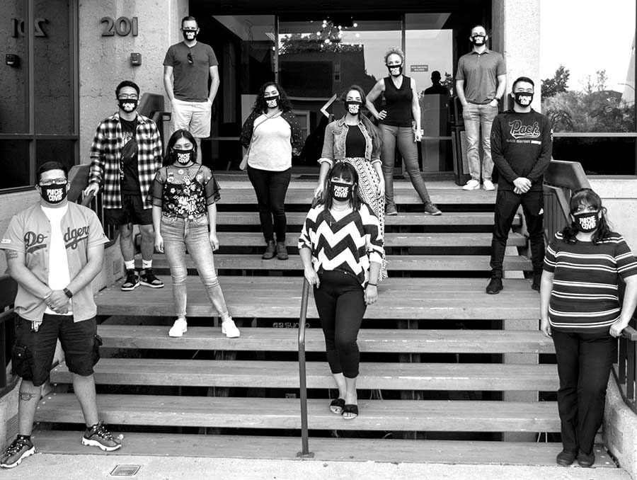 The Nevada Public Health Training Center’s #COVIDCrew stands on stairs with face coverings socially distanced.