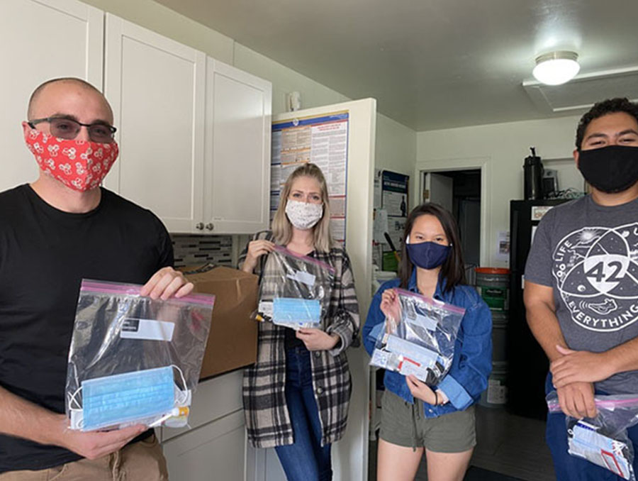 A photo of UNR Med's Health and Hygiene Student Interest Group leaders posing with kits of health and hygiene products for underserved populations. 