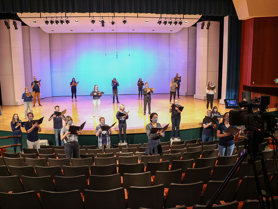 Choir sings in masks on stage