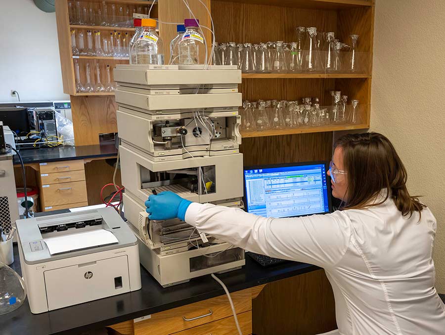 Lab assistant adding samples to a machine