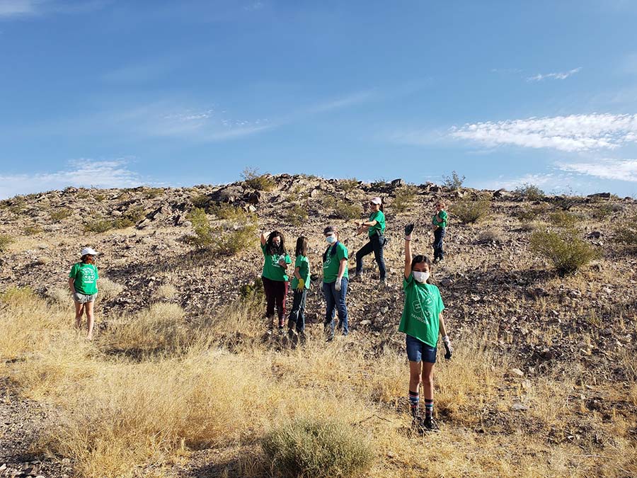 4-H youth clearing trash out of the desert