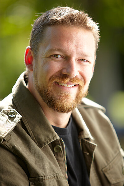 Portrait of a man with blonde hair posing for the camera