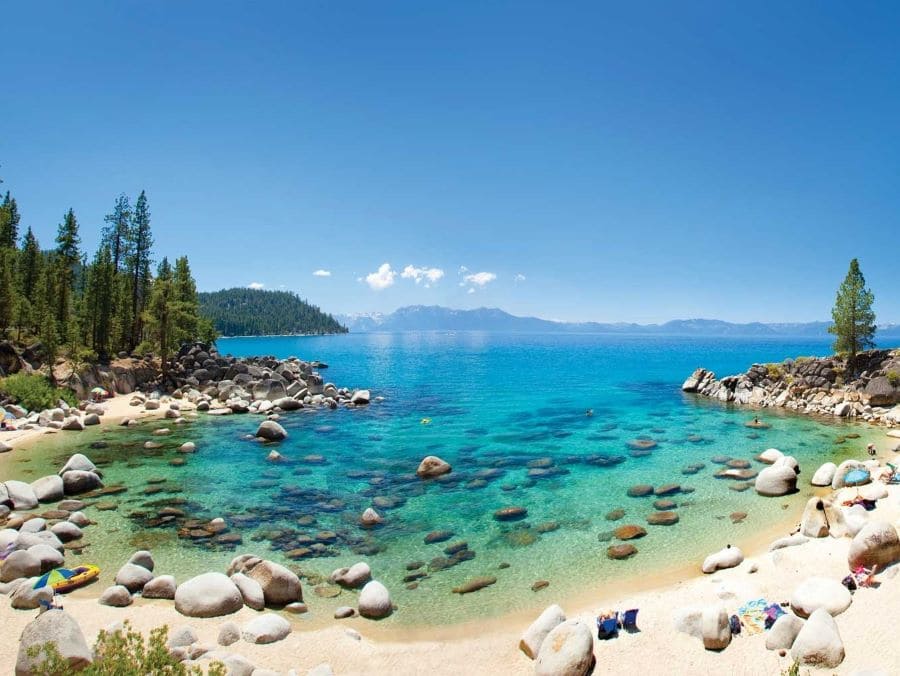 View of a beach and the blue water of Lake Tahoe