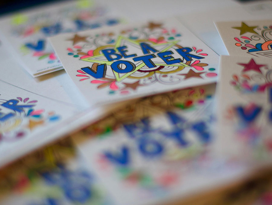 Colorful sticker with the words 'Be a voter'