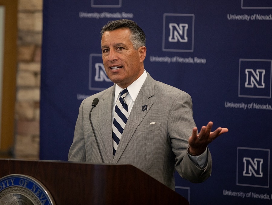 President Brian Sandoval speaking behind a podium
