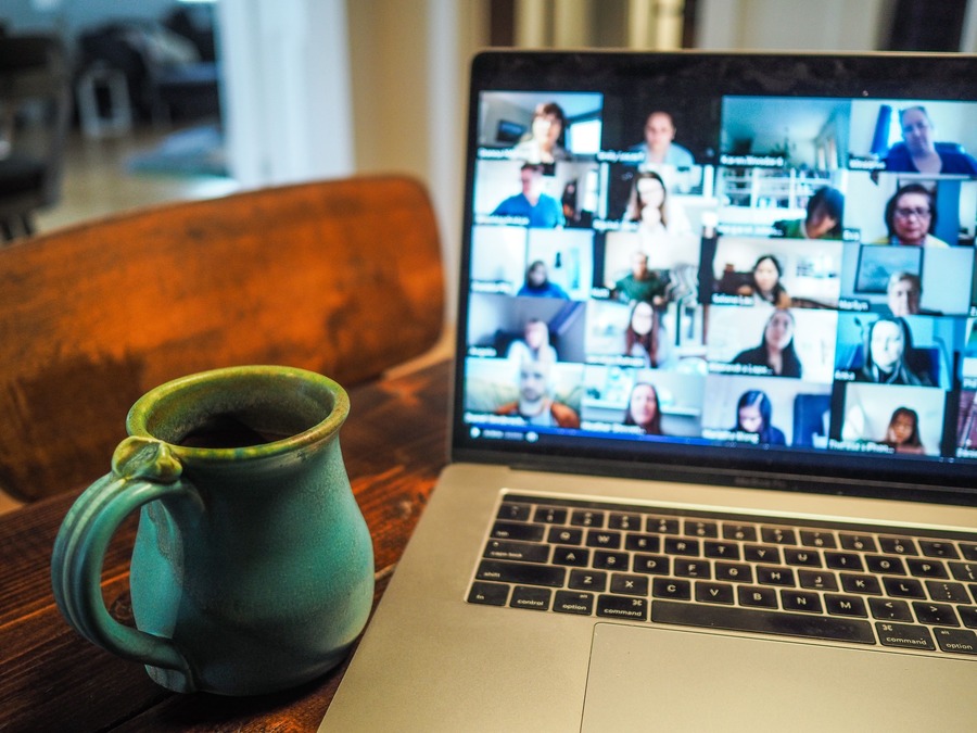 A computer with a virtual meeting on the screen