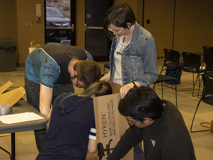 Students working on a cardboard box