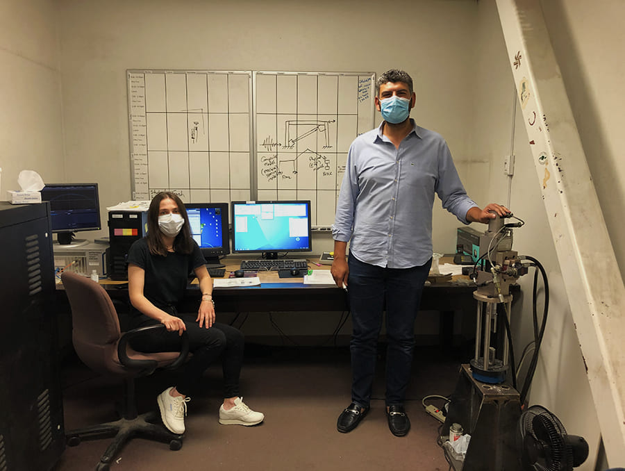 Two people in small simulations lab with samples and computers