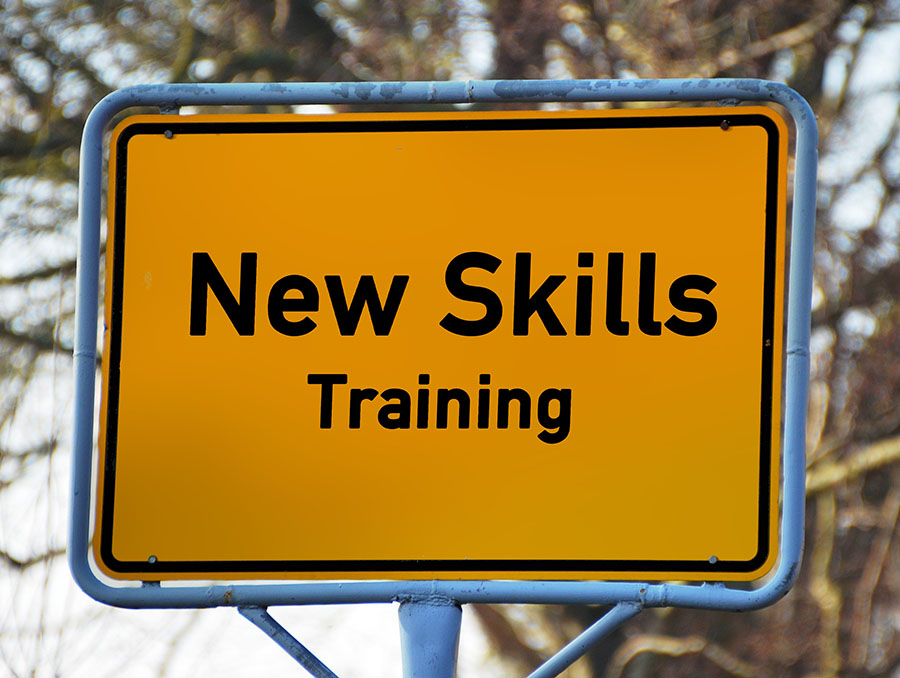 Yellow road sign with the text, "New Skills Training" 