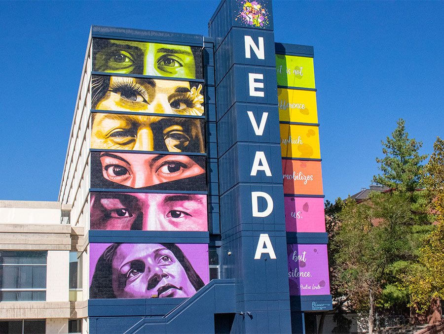 Sierra Hall mural featuring six sets of diverse eyes and faces with Nevada painted down the column