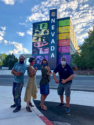 Team members standing in front of Sierra Hall mural