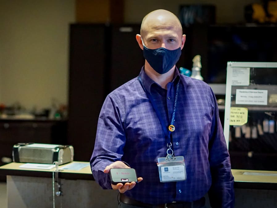 Daniel Fergus, manager of lendable technology at the University of Nevada, Reno holds a hotspot device available for check out.